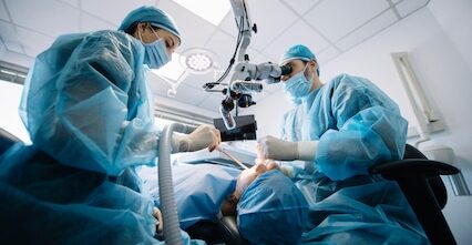 Dentist during a dental intervention with a patient. Dental clinic concept.